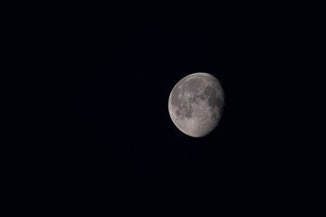 A waning gibbous moon against a black sky