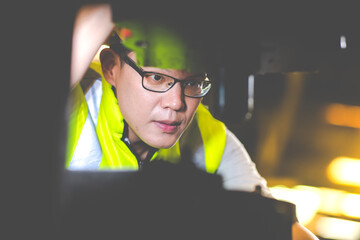 Wall Mural - Asian man worker wearing safety hardhat helmet control lathe machine to drill components. Metal lathe industrial manufacturing factory