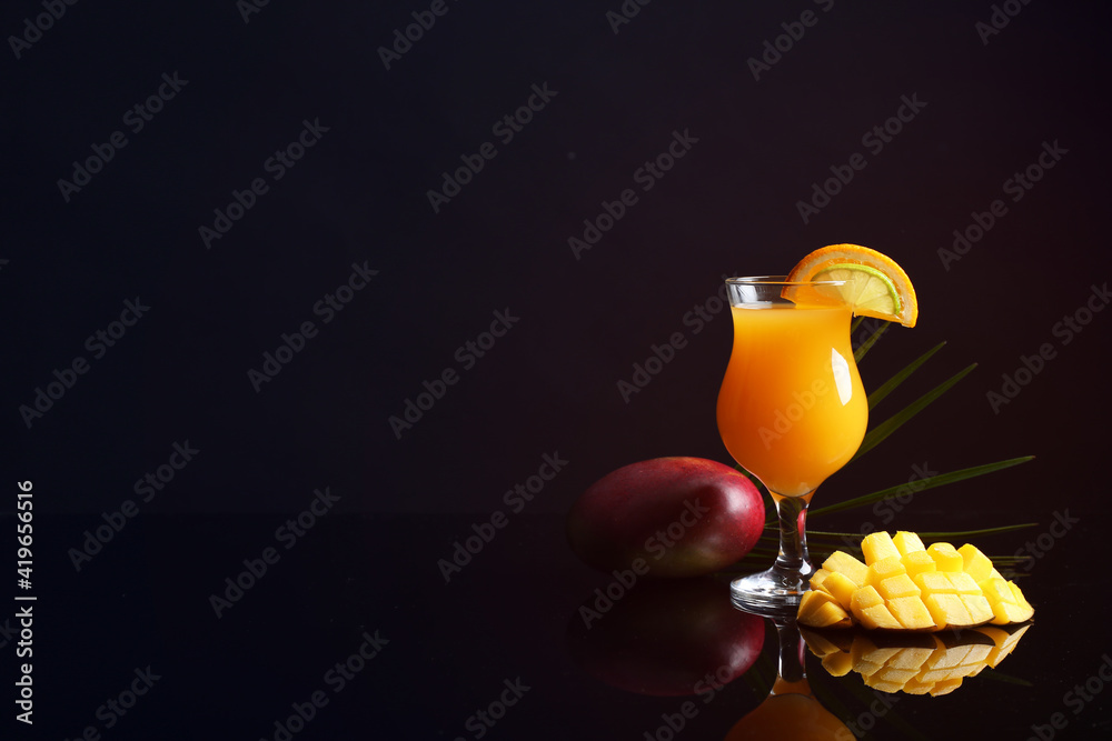Glass of tasty mango margarita on dark background
