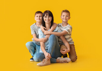 Poster - Happy mother and cute children on color background