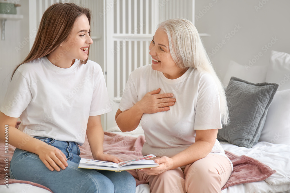 Young woman and mother spending time together at home
