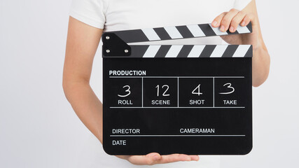 Hands is holding black Clapperboard or movie slate write in number. it use in video production ,film, cinema industry on white background.