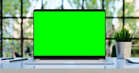 Poster - Laptop with blank green screen. Static footage with trees swaying or moving in the wind. Home interior or loft office background, 4k 24fps UHD, loop video