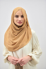 Wall Mural - Portrait of young muslim woman wearing hijab on isolated white background