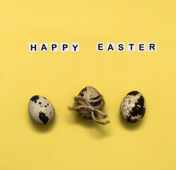 Bright colored eggs on a yellow background. Easter theme, holiday. Happy easter card with copy space for text in minimalist easter style. Color of the year 2021. Bright yellow