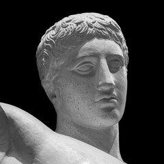 Head detail of the ancient man sculpture. Stone face isolated on black background. Antique marble statue of mythical hero character