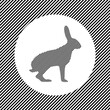 A large hare symbol in the center as a hatch of black lines on a white circle. Interlaced effect. Seamless pattern with striped black and white diagonal slanted lines
