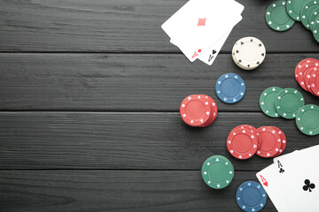 Poker chips on black wooden background. Casino