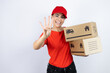 © Irene - Young beautiful woman wearing courier uniform holding delivery packages showing and pointing up with fingers number four while smiling confident and happy