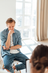 Upset caucasian man communicating with his psychologist, at a psychotherapy session to maintain internal health.