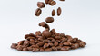 © Lukas Gojda - Falling Roasted Coffee Beans on White Background, close-up.