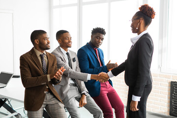 Wall Mural - team of young african people in office with handshake 