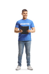 Canvas Print - Full length portrait of a young man volunteer holding a clipboard