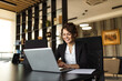 © bnenin - Positive manager using laptop in the office, portrait.