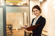 © bnenin - Portrait of a young business executive, smiling at camera.