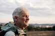 © VITTA GALLERY/Westend61 - Smiling senior man looking away at countryside during sunset