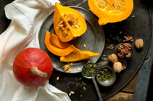 Walnuts, Pumpkin Seeds And Red Kuri Squashes On Rustic Baking Sheet