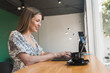 © MORNINGVIEW AGENCY/Westend61 - Smiling businesswoman working over laptop on table in cafe