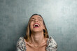© MORNINGVIEW AGENCY/Westend61 - Close-up of beautiful woman with eyes closed laughing against concrete wall