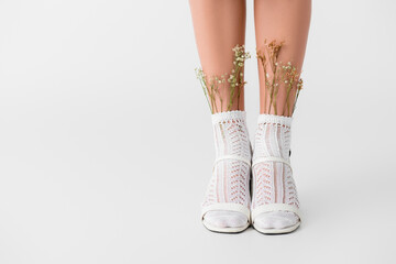 Sticker - cropped view of woman in socks with flowers and heeled footwear standing isolated on white