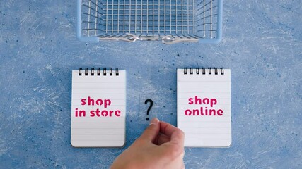 Wall Mural - shop in store vs shop online texts on notepads with shopping basket and question mark symbol of indecision, competition and retail industry