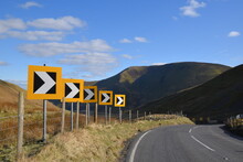 A Sharp Corner With Warning Signs On A Welsh Mountain Road