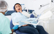 © JackF - Professional doctor man talking with patient in medical chair