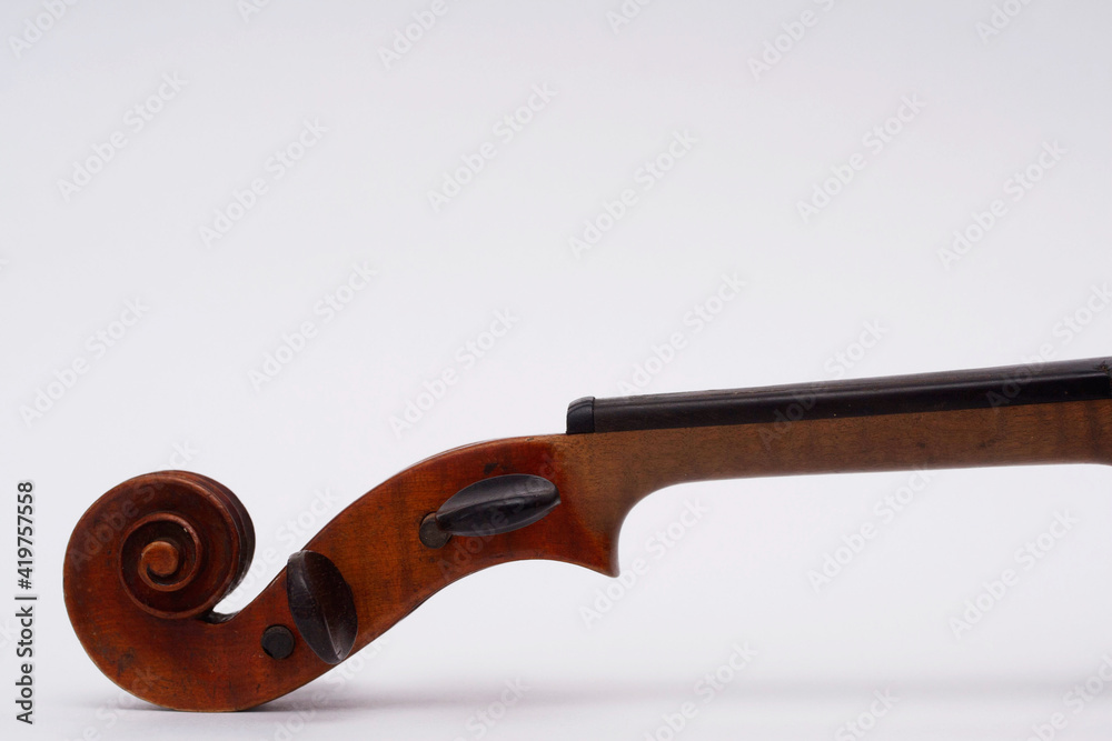 Violin scroll with pegs and fingerboard without strings on white ...