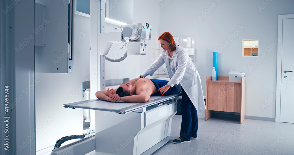 Female doctor doing chest X ray scan of male patient Stock Photo ...