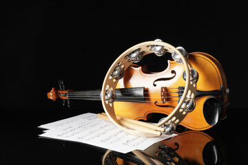 Wall Mural - Tambourine, violin and music notes on dark background