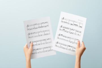 Poster - Woman holding music notes on color background