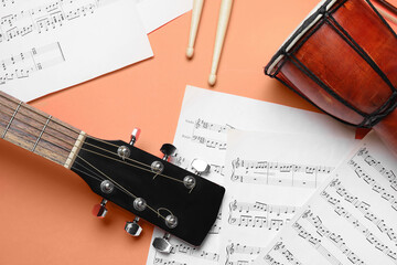 Wall Mural - Acoustic guitar, drumsticks, djembe and music notes on color background, closeup