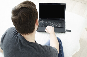 guy with laptop at home on the bed. lifestyle