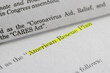 © Tada Images - Closeup of the documents of both the Cares Act (Coronavirus Aid, Relief, and Economic Security Act) and the American Rescue Plan Act of 2021.