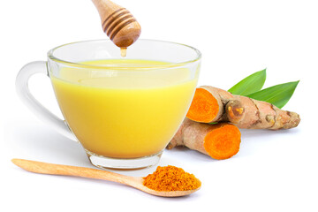 Wall Mural - Tumeric milk ( turmeric latte, golden milk ) in glass cup, curcumin root and powder in wooden spoon with honey isolated on white background.