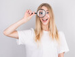 © Studio Nova - Close up portrait of cheerful beautiful girl looking through magnifying glass isolated on white background