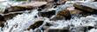Leinwandbild Motiv Close up of river stream on stones