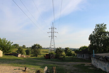 high-voltage tower against a blue sky with a place for text