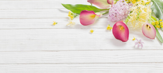 Wall Mural - beautiful flowers on white wooden background