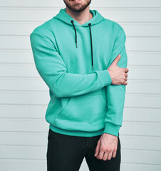 Poster - bearded guy wears blue hoodie. no logo color hoodie. clothing line mock up