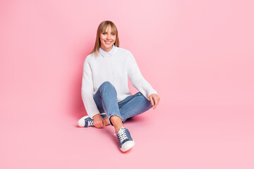 Wall Mural - Full length body size view of lovely cheerful girl wearing modern casual look sitting isolated over pink pastel color background