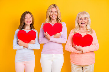 Canvas Print - Photo of grey haired lady mother and daughter hug heart figure good mood isolated on yellow color background