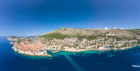 Canvas Print - Aerial panorama drone shot of Dubrovnik old town coastline by Adriatic sea in Croatia summer noon