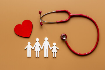  Flat lay with heart, stethoscope and family figure. Medical care concept