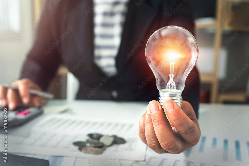 hand holding light bulb. idea concept with innovation and inspiration - obrazy, fototapety, plakaty 