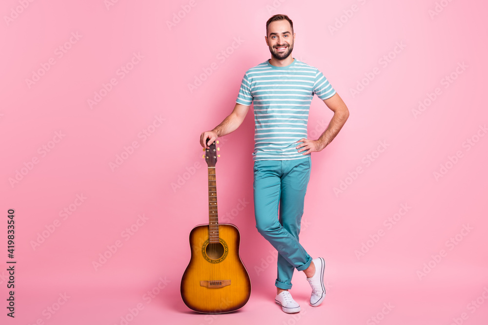 Full length body size view of attractive cheerful guy holding string guitar country style singer isolated over pink color background - obrazy, fototapety, plakaty 