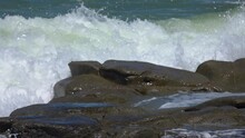 Water Crashing Into Rocks At The Beach In Slow Motion