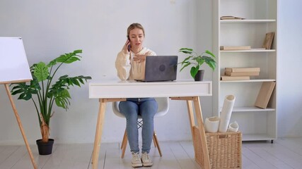 Poster - young caucasian businesswoman talking by phone with client or partner in small office entrepreneur sitting at the desk