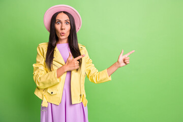 Sticker - Photo portrait of amazed woman pointing looking at copyspace smiling staring in pink hat isolated on bright green color background