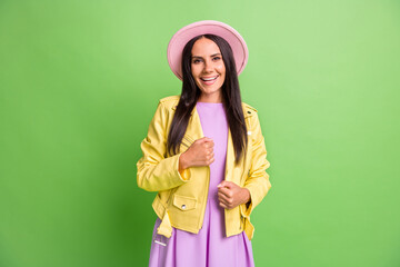 Sticker - Photo portrait of brunette girl in pink hat yellow leather jacket smiling isolated on bright green color background